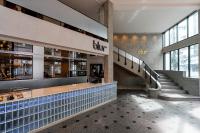 a lobby of a shopping mall with a person sitting at a counter at Wangkaew Hotel in Phitsanulok