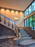 a staircase in a building with a sign on the wall at Wangkaew Hotel in Phitsanulok