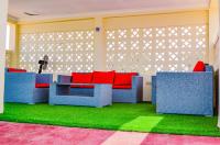 a living room with blue and red furniture and grass at Ateker Hotel in Lodwar
