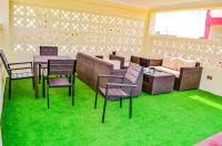 a room with chairs and a table and a couch at Ateker Hotel in Lodwar