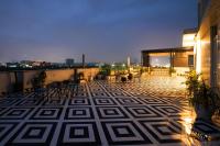 a balcony with a geometric patterned floor on a building at Aarchh Regency Noida in Noida