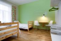 a small room with a bed and a chalkboard on the wall at Orange Cat Rooms in Riga