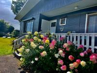 a bunch of flowers in front of a house at Le Chalet de Marguerite in Francorchamps