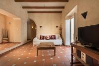 a living room with a couch and a flat screen tv at Apartamento Guzman el Bueno in Tarifa