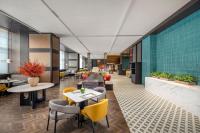 a restaurant with tables and chairs in a room at Crowne Plaza Beijing Tongzhou in Beijing