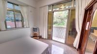a room with a bed and a large window at Alishan Fenqihu Green Land Homestay in Guanghua