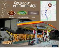 een bord voor een em tone ayu tankstation bij Belo Hotel in Tomé-Açu