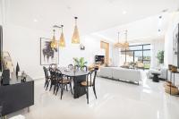a dining room and living room with a table and chairs at Al Bandar Luxury Villa with private pool - Al Dana Island Fujairah in Fujairah