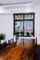 ein leerer Raum mit einem Holztisch und einem großen Fenster in der Unterkunft Bamboo House Cat Ba in Cát Bà