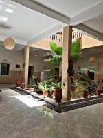 a lobby with potted plants in a building at Riad Tazoulte in Agdz