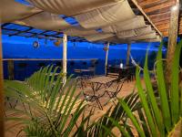 a patio with tables and chairs under an umbrella at Villas del lago resort in Colorado