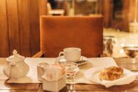 a table with a cup of coffee and a plate of food at Hotel Austral Bahia Blanca in Bahía Blanca