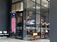 a large glass building with an american flag in it at Vetro 11 Suites - Kota Kinabalu - J-Residences Welcomes You! in Penampang