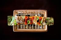 a plate of food with a sandwich on a rack at Villa Tokay - The Luxury Resort in Gili Air