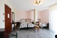 A bed or beds in a room at B&B La Castellana
