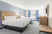 a hotel room with two beds and a television at Quality Inn & Suites On The River in Glenwood Springs