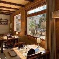 un comedor con mesas y una gran ventana en Au Sans Souci, en Saint-Paul-lès-Monestier