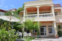 a house with chairs and an umbrella in front of it at Bellalia 貝拉利亞 花蓮民宿 in Hualien City