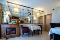 a dining room with a table and a fireplace at Pensiunea Dapa Ciubar & Sauna in Predeal