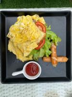 a plate of food with a salad and carrots and a sauce at The Regizt Jomtien Pattaya in Jomtien Beach
