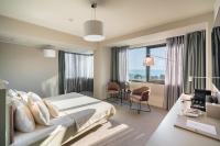a hotel room with a bed and a desk and window at Millennium Hub &amp; Hotel in Constanţa
