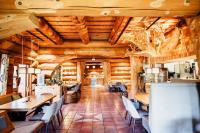 a restaurant with wooden walls and tables and chairs at Ferienparadies Schwarzwälder Hof in Seelbach