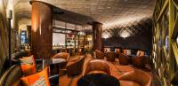 a restaurant with leather chairs and a bar at The Prince Gallery Tokyo Kioicho, a Luxury Collection Hotel in Tokyo