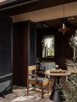 a patio with a table and chairs and a dining room at 大理空山语 风眠艺术海景酒店 Dali Kongshanyu Art Seaview Hotel in Dali Airport