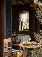 a dining room with a table and a table and chairs at 大理空山语 风眠艺术海景酒店 Dali Kongshanyu Art Seaview Hotel in Dali Airport