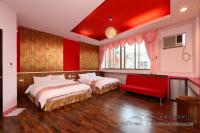 a bedroom with two beds and a red ceiling at Foot Track Bed and Breakfast in Hualien City