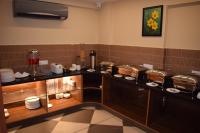 a room with a kitchen with a counter with food at Hotel Skyview in Kondapur
