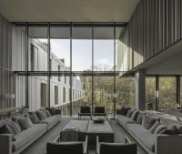 a large room with couches and tables and large windows at Hotel Arima &amp; Spa - Small Luxury Hotels in Donostia-San Sebastián
