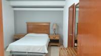 Un dormitorio pequeño con una cama y un espejo. en Hotel los coloniales de reynosa, en Reynosa