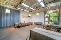 a dining room with tables and chairs and windows at Feiwan B&B in Nan'an