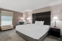 Un dormitorio con una gran cama blanca y una gran ventana. en Quality Inn &amp; Suites Union City - Atlanta South, en Union City