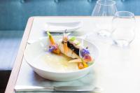 a white plate of food on a table at Kasteel Kerckebosch in Zeist
