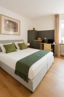 a bedroom with a large white bed with green pillows at Hotel weisses Lamm in Bruchsal