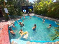 a group of people playing in a swimming pool at Tower Bridge Hostel in Puerto Escondido