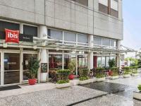 a building with potted plants in front of it at ibis Tambore in Barueri