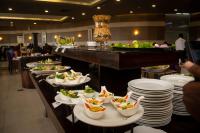 a buffet line with plates and bowls of food at Hotel Presidential in Port Harcourt