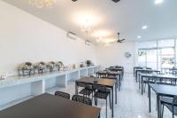 a row of tables and chairs in a restaurant at Andaman Sea Best Pool Access and Villas in Phuket Town