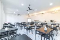 a dining room with tables and chairs and a bar at Andaman Sea Best Pool Access and Villas in Phuket Town