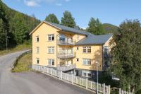 a large yellow building on the side of a road at Åre Travel - Brygghusen in Åre