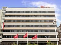 a building with red canadian flags in front of it at ibis Leiden Centre in Leiden