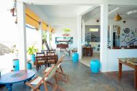 a living room with a table and chairs at Vuai Bungalows & Restaurant in Kiwengwa