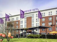 a hotel with purple flags in front of a building at Mercure Kamen Unna in Kamen