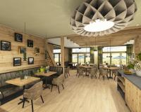 un ristorante con tavoli e sedie e un grande lampadario di WALDGUT Naturresort a Bad Gottleuba-Berggiesshübel