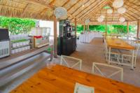 zona de comedor con mesas y sillas y cocina en HOTEL BIULÚ, en Santa Cruz Huatulco