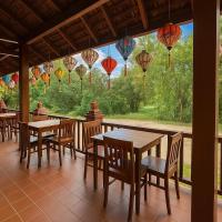ein Restaurant mit Tischen und Stühlen und bunten Laternen in der Unterkunft Villa Khili Phousi in Luang Prabang