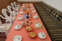 a long long table with plates of food on it at Auberge la belle vue dades in Akhendachou nʼAït Ouffi